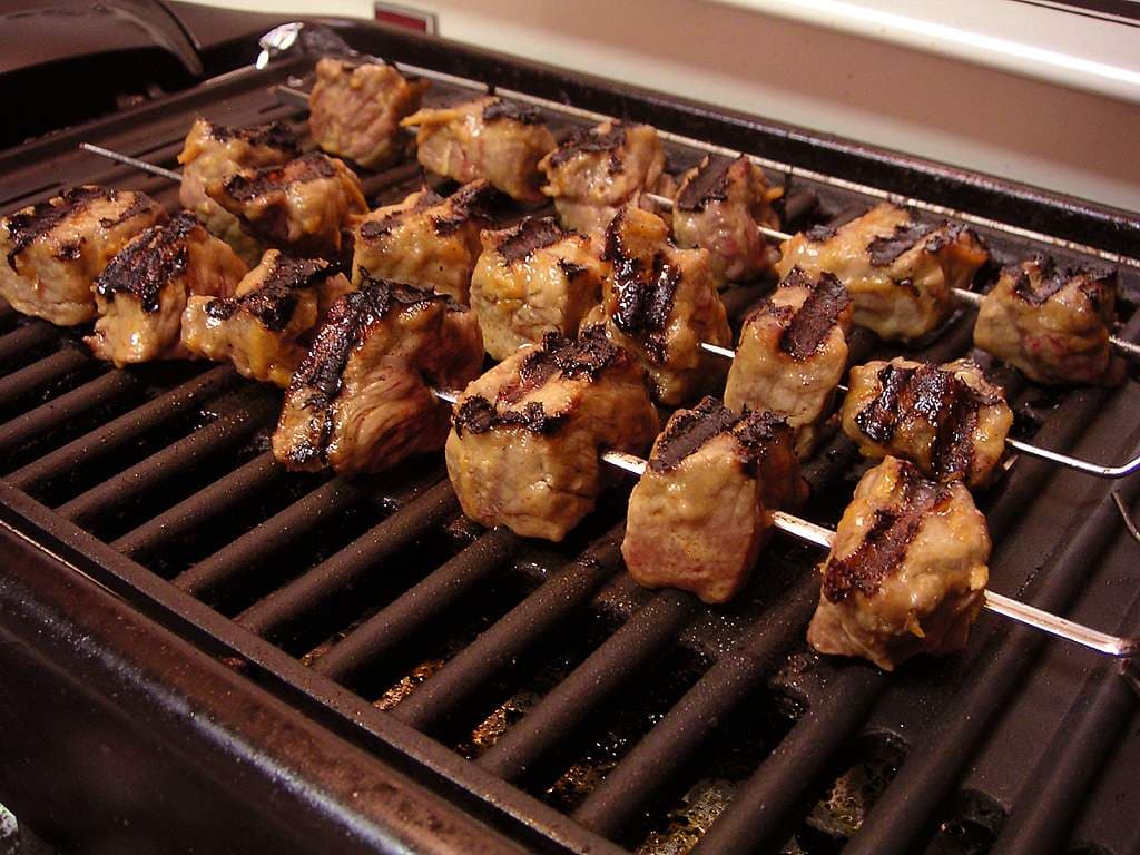 Outdoor barbecue with a cooking grate, the usual reason an Australian deck is asked to become a kitchen.