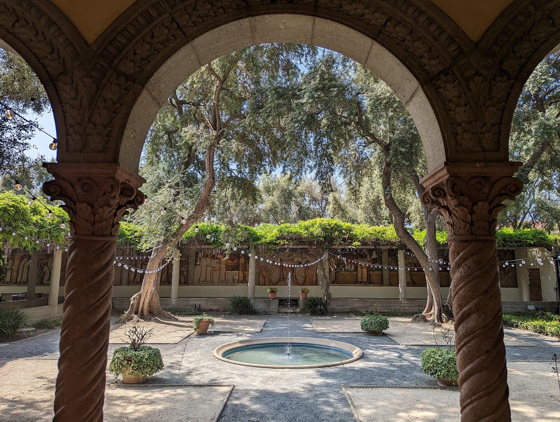 An arcaded courtyard looking onto a shared garden, the overlooking problem a raised deck creates next door.