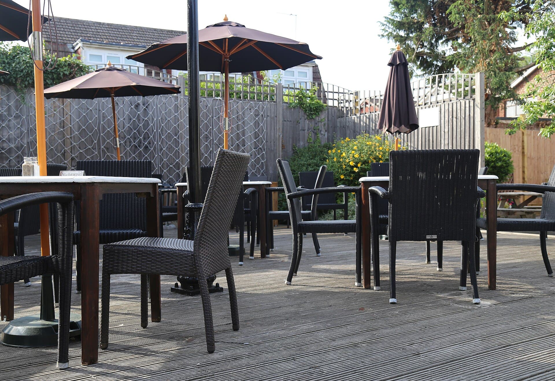 A raised timber deck with outdoor furniture, the kind of platform that needs a planned way up and a threshold you can cross.